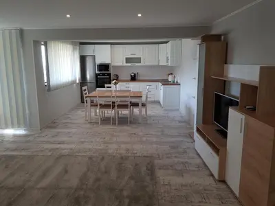 a kitchen and dining room with a table and chairs at United Apartments 2 in Sandanski
