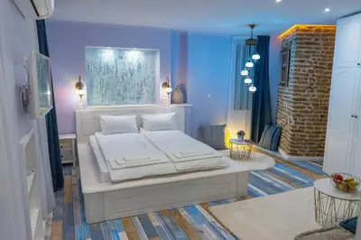 a bedroom with a white bed in a room at SABORNA 25 GUEST HOUSE in Plovdiv