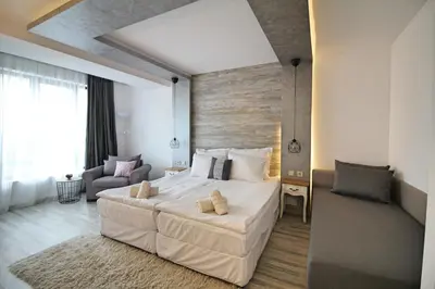 a bedroom with a large white bed in a room at Ice Jewel Chalet, Bansko, 200 meters from the Gondola, 20 улица „Свети Иван Рилски“ in Bansko