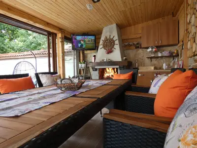 a dining room with a long table and a tv at Ice Jewel Chalet, Bansko, 200 meters from the Gondola, 20 улица „Свети Иван Рилски“ in Bansko