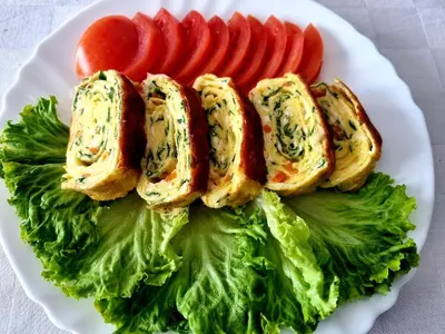 a white plate of food with lettuce and tomatoes at Motel Thessaloniki in Sandanski
