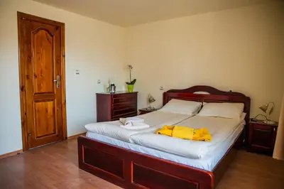 a bedroom with a bed with two towels on it at Pri Ani Guest House in Bansko