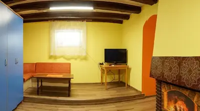 a living room with a couch and a television at Апартамент 