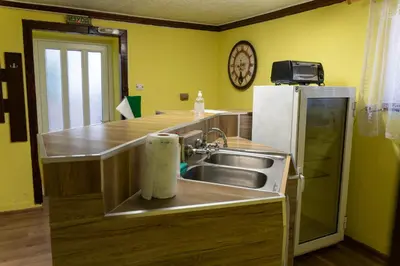 a kitchen with a sink and a refrigerator at Апартамент 