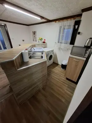 a kitchen with a sink and a microwave at Апартамент 