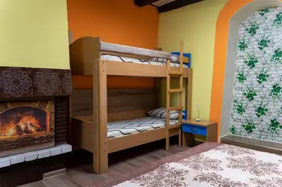 a room with two bunk beds and a fireplace at Апартамент 