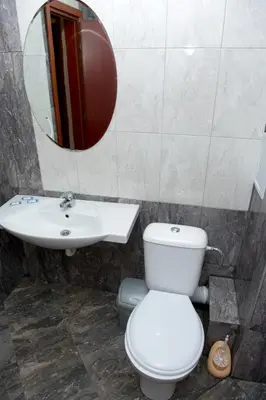 a bathroom with a toilet and a sink and a mirror at St.St. Constantine and Helena in Sandanski