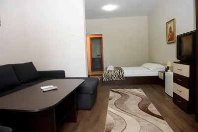 a small living room with a couch and a bed at St.St. Constantine and Helena in Sandanski