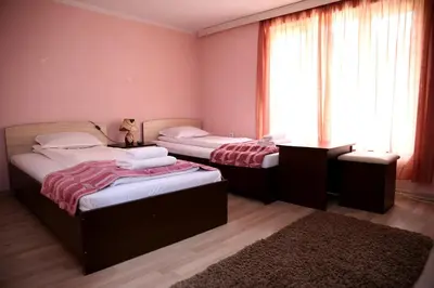 two twin beds in a room with a window at St.St. Constantine and Helena in Sandanski