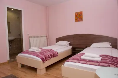 a bedroom with two beds and a bathroom at St.St. Constantine and Helena in Sandanski