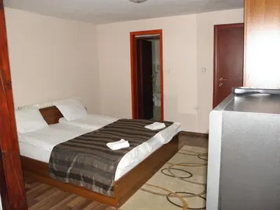 a bedroom with a bed with two towels on it at St.St. Constantine and Helena in Sandanski
