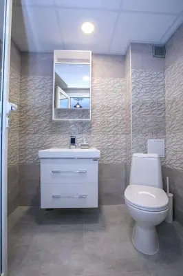 a bathroom with a toilet and a sink and a mirror at Sunpark Studios in Sandanski