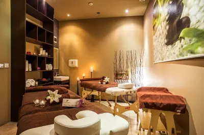 a room with two beds and a table and chairs at Hotel Perun Lodge in Bansko