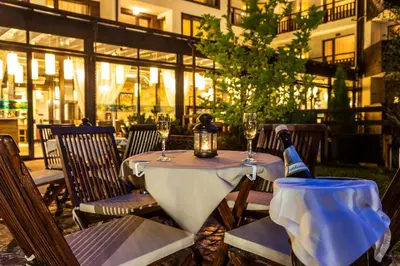 a table with a bottle of wine on top of it at Hotel Perun Lodge in Bansko