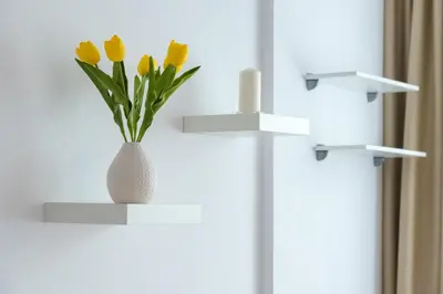 a vase with yellow flowers sitting on a shelf at Comfort.Chic.Charming Apt with Terrace near NDK in Sofia