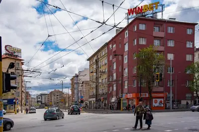 a group of people crossing a street in a city at Comfort.Chic.Charming Apt with Terrace near NDK in Sofia