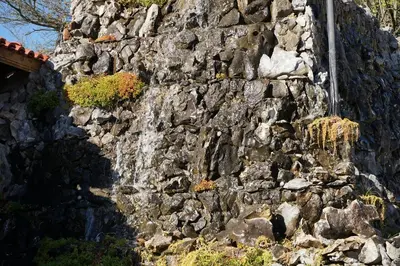 a stone wall with a waterfall on it at Complex Praveshki Hanove in Pravets