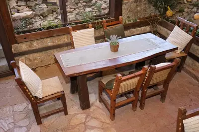 a wooden table and chairs on a patio at Complex Praveshki Hanove in Pravets