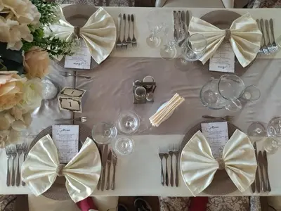 a table with a white table cloth with bows on it at Complex Praveshki Hanove in Pravets
