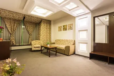 a living room with a couch and a table at Earth & People Hotel & SPA - Free Parking & Swimming Pool in Sofia