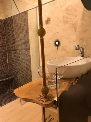 a bathroom with a sink on top of a counter at Come inn - 24h Self Check-in in Sofia