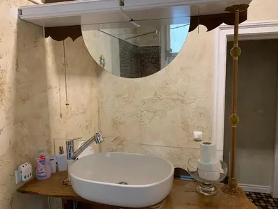 a bathroom with a white sink and a mirror at Come inn - 24h Self Check-in in Sofia