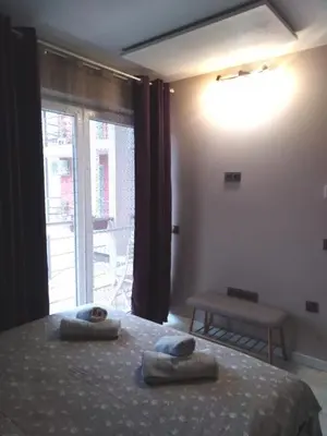 a bedroom with a bed with two towels on it at A-Apartment in Krasnovo