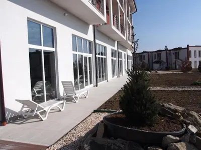 a building with two chairs and a christmas tree at A-Apartment in Krasnovo