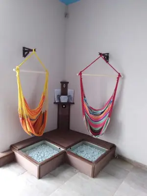 two hammocks hanging on a wall in a room at A-Apartment in Krasnovo