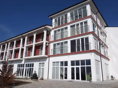 a white building with windows and balconies at A-Apartment in Krasnovo