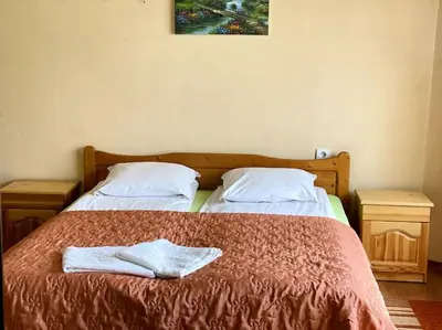 a bedroom with two beds with towels on the bed at Vila Katerina in Yundola