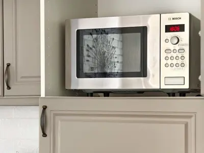 a microwave sitting on top of a kitchen cabinet at Apartment Audrey by SofiaSpot - central, metro to airport in Sofia