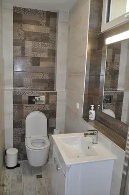 a bathroom with a toilet and a sink at Къща за гости Ирис in Kyustendil