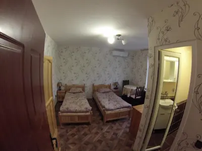 a small room with two beds and a mirror at Къща за гости с минерална вода 