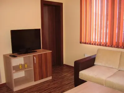 a living room with a couch and a flat screen tv at Guest House Goranovi in Velingrad
