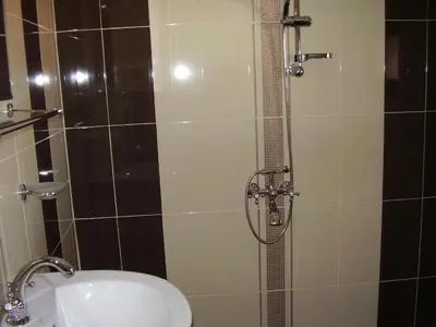 a bathroom with a shower with a toilet and a sink at Guest House Goranovi in Velingrad