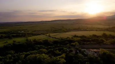 an aerial view of a field with the sunset in the background at C Comfort Hotel & Wellness in Hisarya