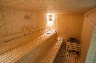 a wooden sauna with a bench in the middle at C Comfort Hotel & Wellness in Hisarya