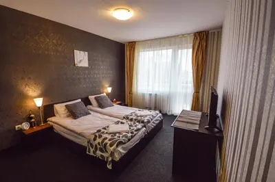 a hotel room with a bed and a television at Elite Spetema Hotel in Sofia