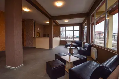 a lobby with couches and a table in a building at Elite Spetema Hotel in Sofia