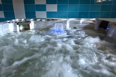 a jacuzzi tub filled with water with a waterfall at хотел Чифлика - комплекс Чифлика in Chiflik
