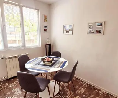 a dining room with a table and chairs at Plovdiv Top Center 2 Bedroom Apartment, FREE Parking in Plovdiv