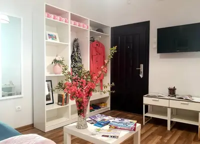 a living room with a vase with flowers on a table at Plovdiv Top Center 2 Bedroom Apartment, FREE Parking in Plovdiv