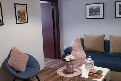 a living room with a blue couch and a table at Plovdiv Top Center 2 Bedroom Apartment, FREE Parking in Plovdiv