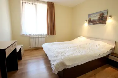 a bedroom with a bed and a window at Guest House Ela in Bansko