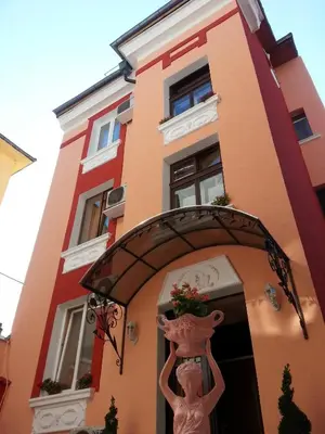 a statue of a woman standing in front of a building at Orange Flower Apartments in Sofia