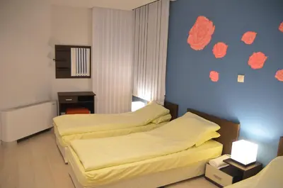 a bedroom with two beds and a blue wall at Villa Galiana in Simitli
