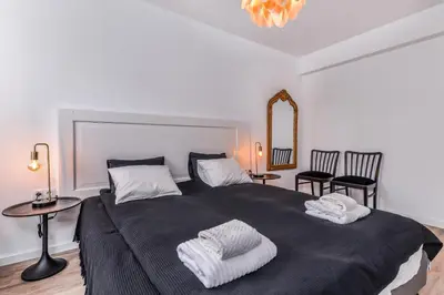 a bedroom with a large bed with two towels on it at 66 Apartment - Stylish Two Bedroom in Lozenets District by Flat Mаnager in Sofia