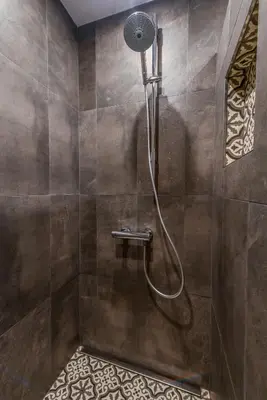 a shower with a hose in a bathroom at 66 Apartment - Stylish Two Bedroom in Lozenets District by Flat Mаnager in Sofia