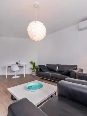 a living room with a couch and a table at 66 Apartment - Stylish Two Bedroom in Lozenets District by Flat Mаnager in Sofia